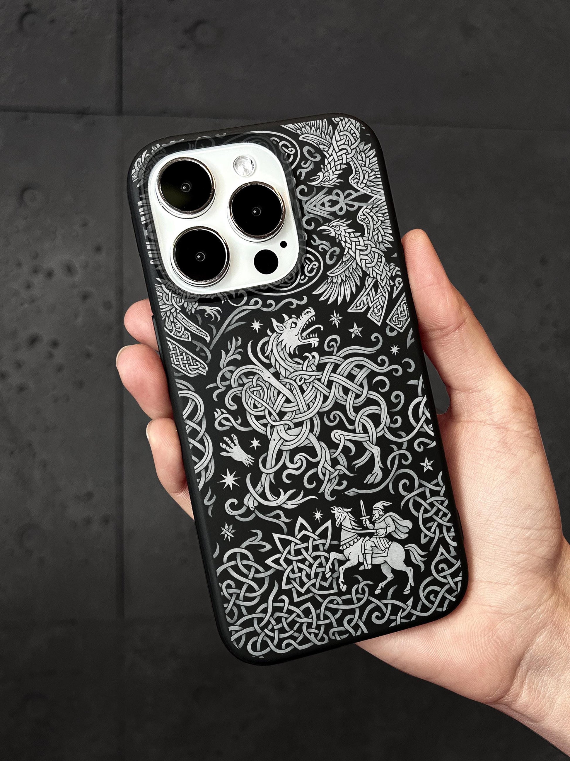 a hand holding a black and white iphone case