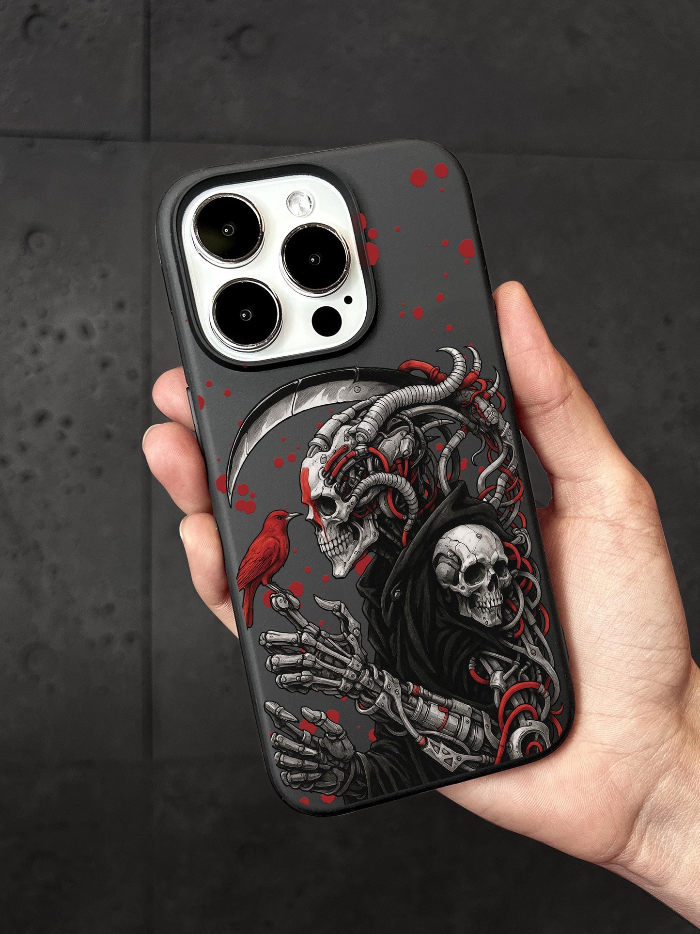 A person is holding a phone case with a skull design and a bird.