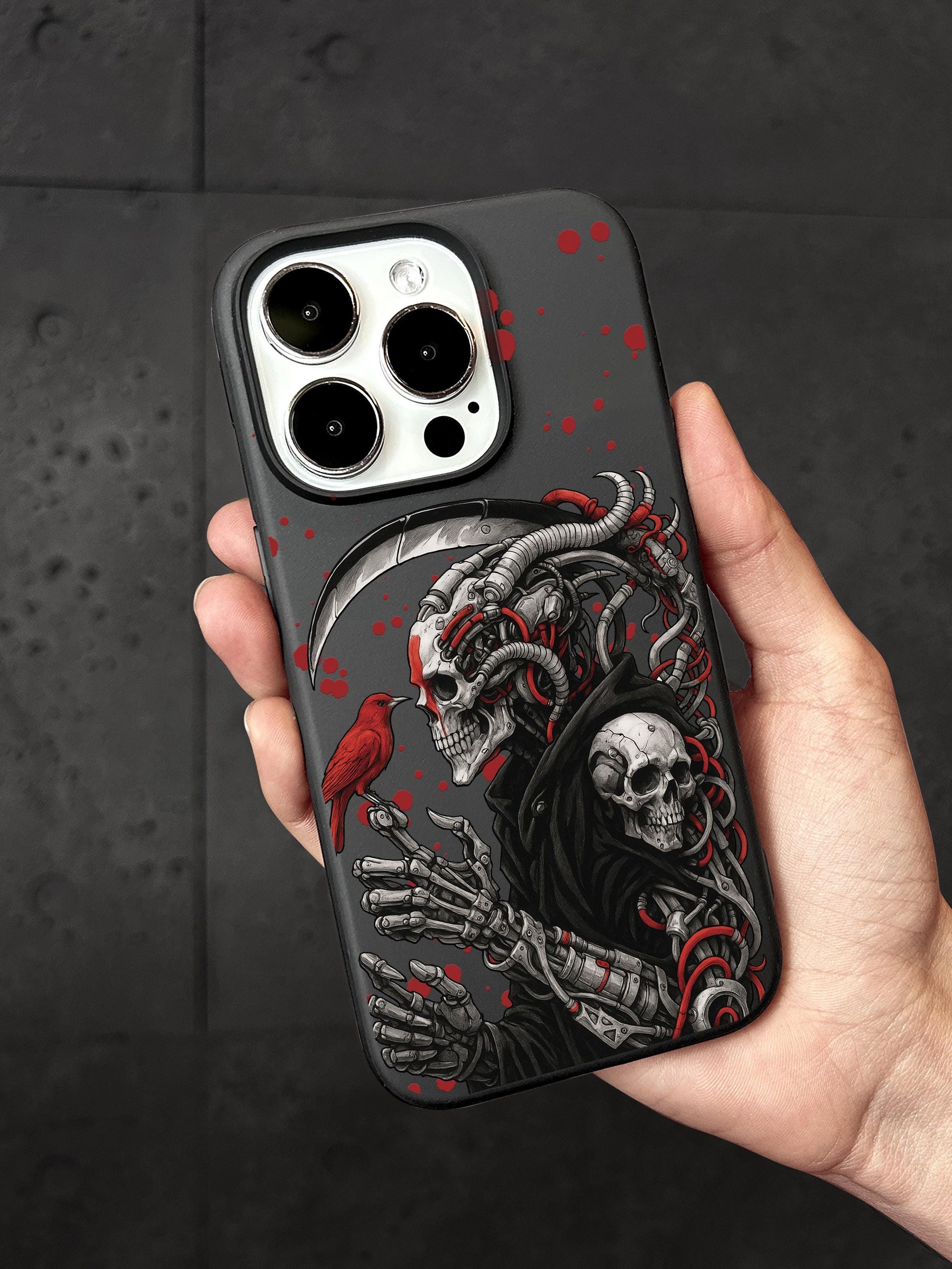 A person is holding a phone case with a skull design and a bird.