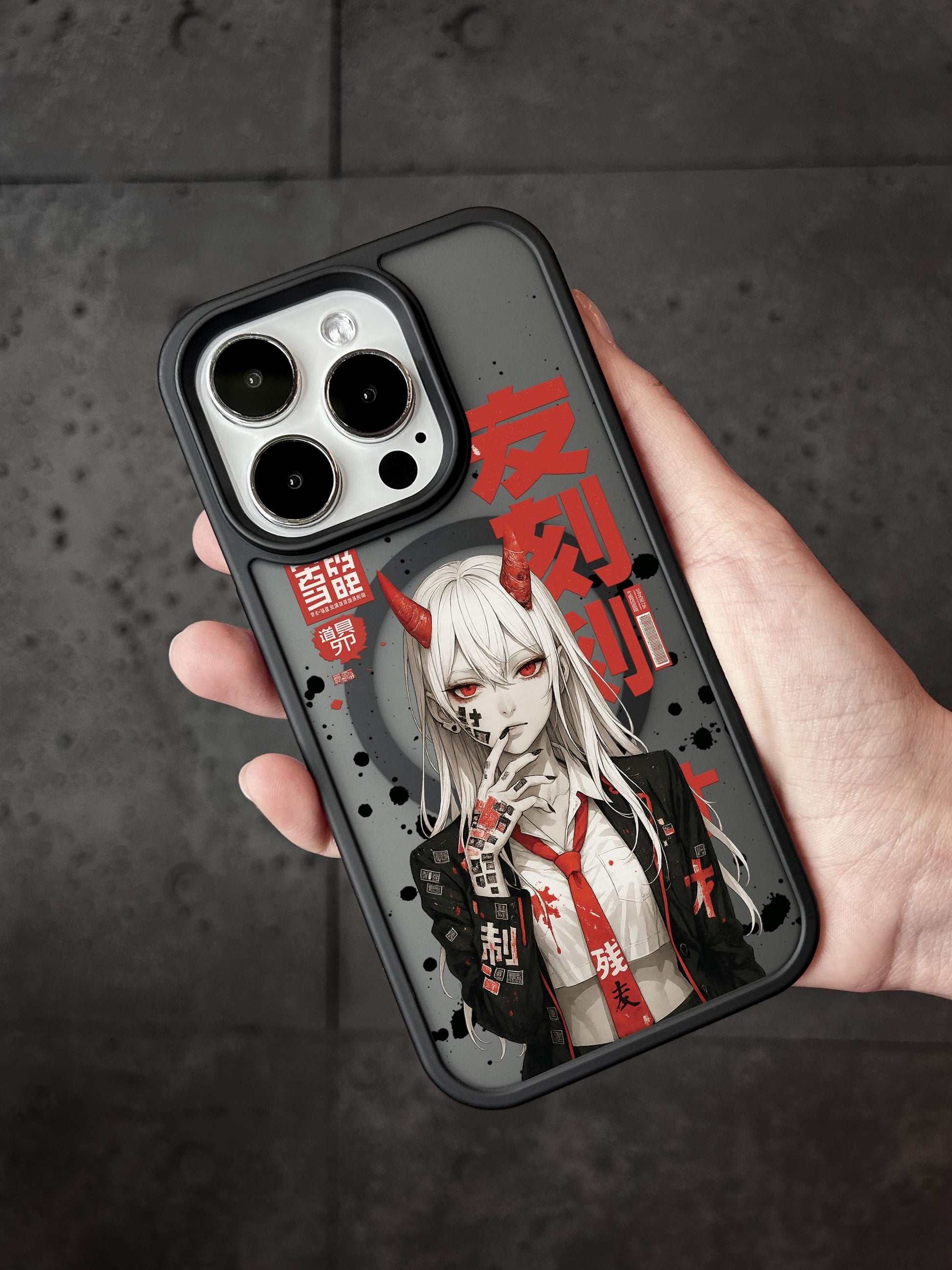 A person&#39;s hand holding a phone case featuring an anime-style illustration of a character with horns and red eyes.