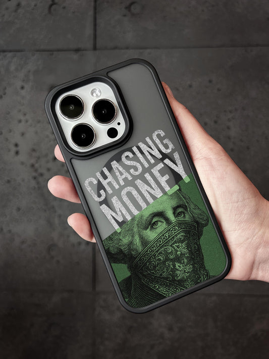 A person&#39;s hand holding a phone case with a design featuring a face wearing a bandana and the text &quot;CHASING MONEY&quot; printed on it.