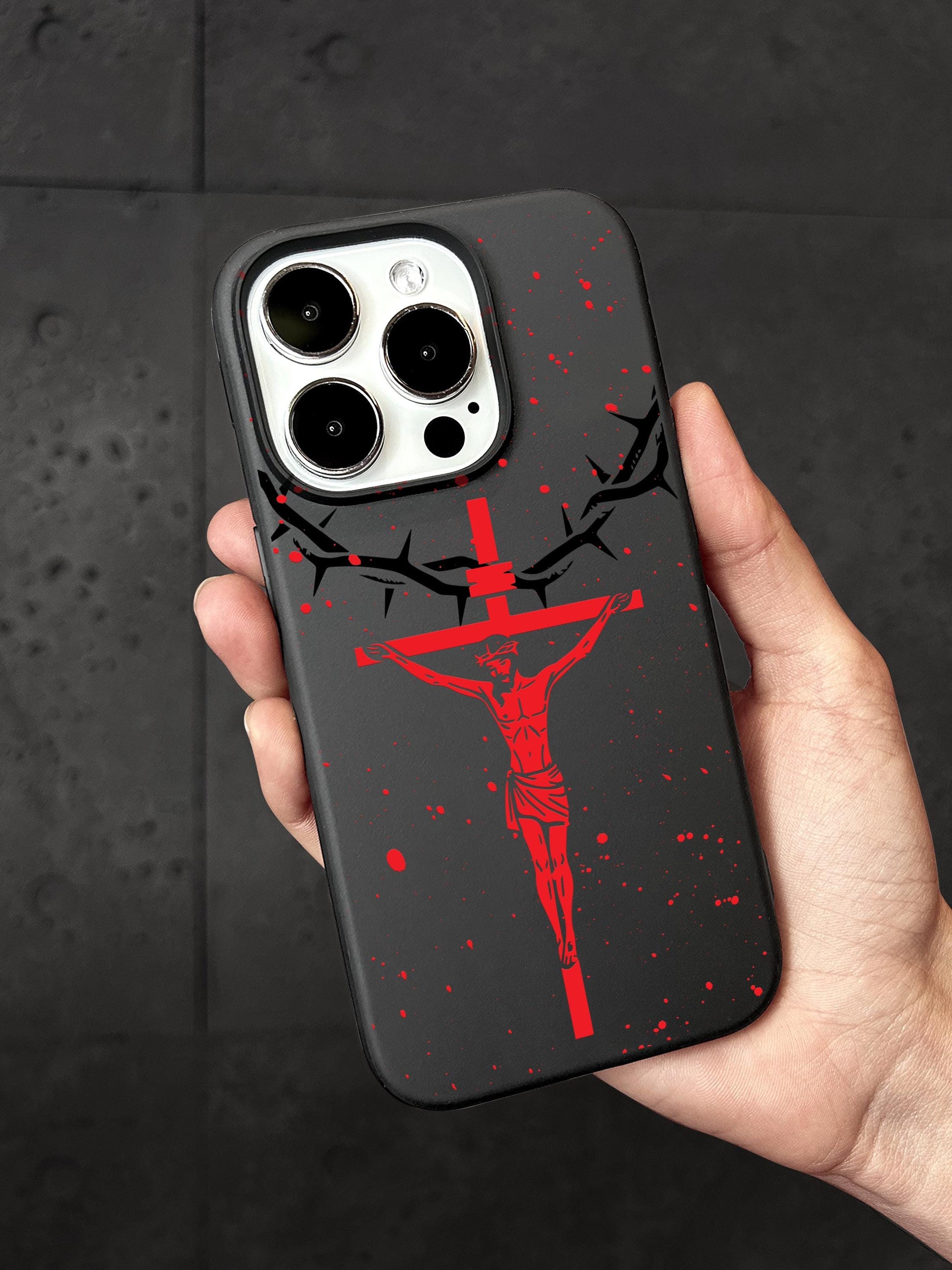 a person holding a phone case with a cross on it