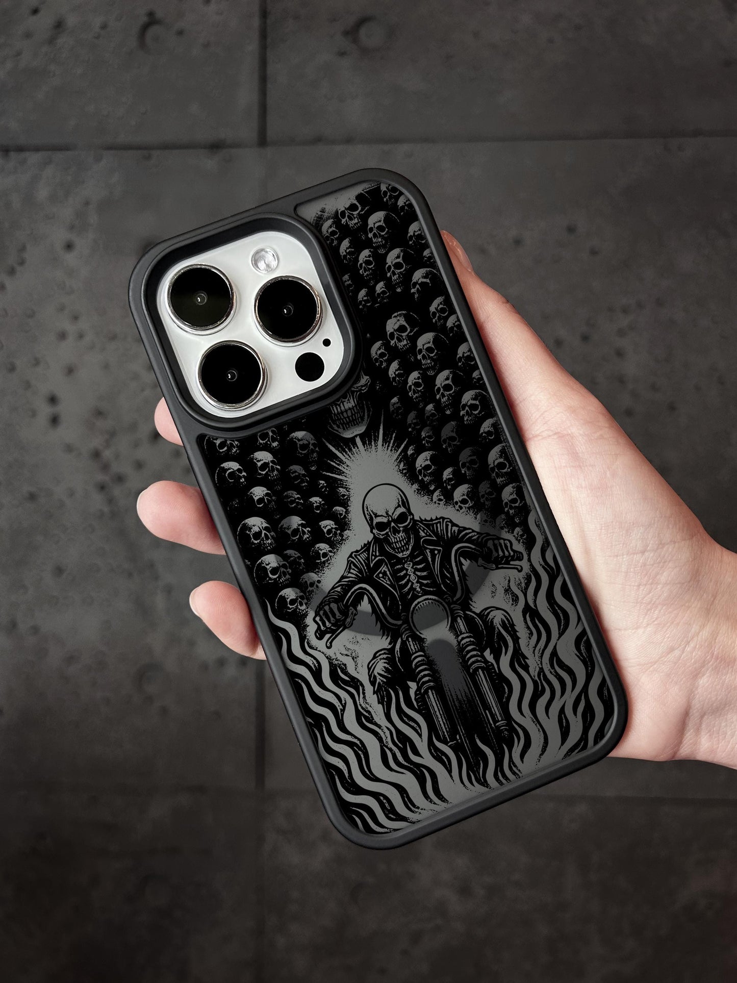 a person holding a phone case with a picture of a skeleton on it