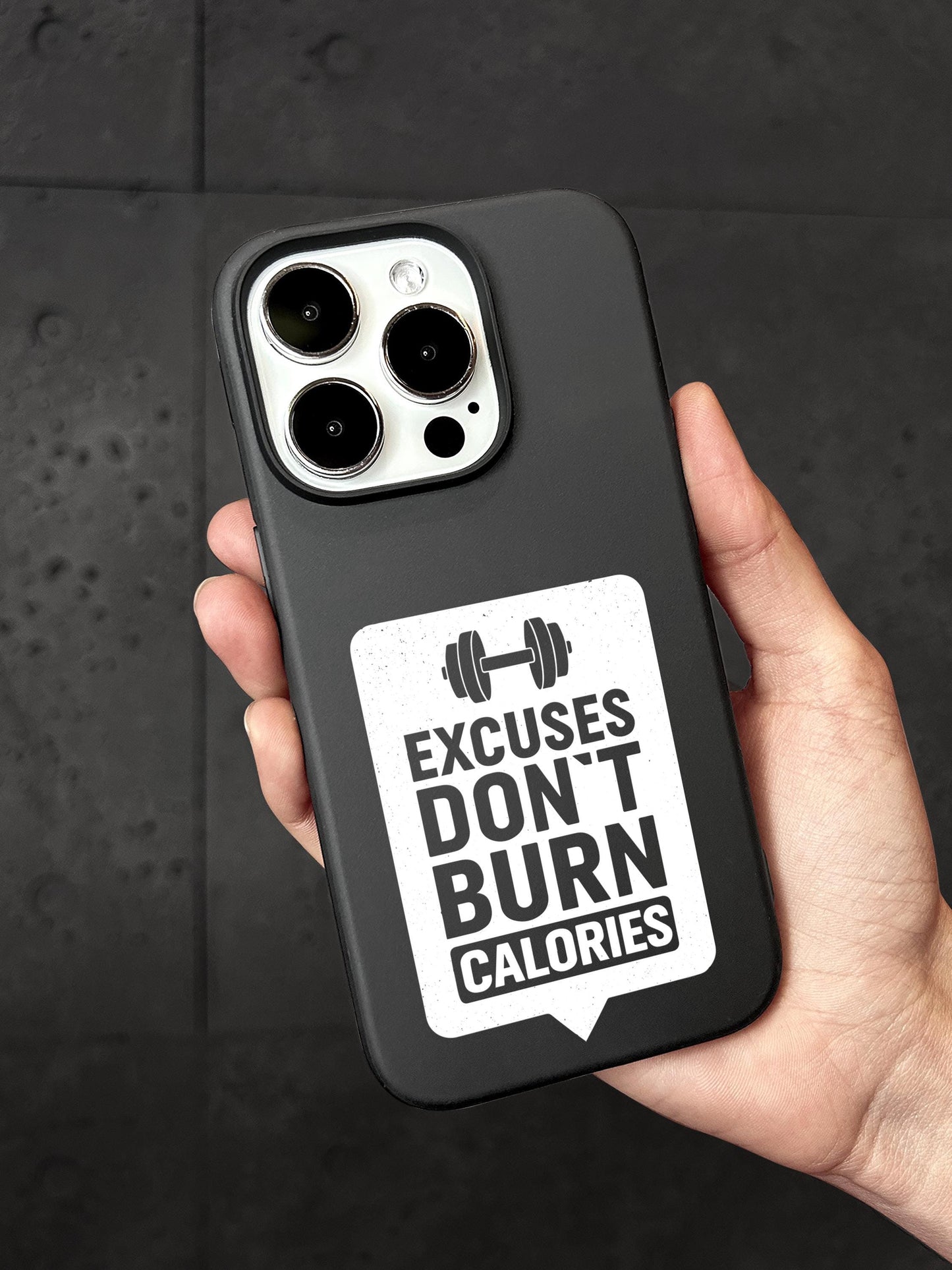 A person&#39;s hand holding a black iPhone case with a sticker on it.