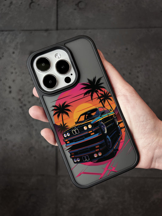 A hand holding a phone case with a colorful graphic of a car and palm trees on it.