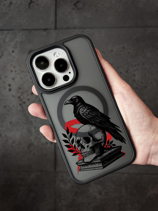 a person holding a phone case with a black bird on it