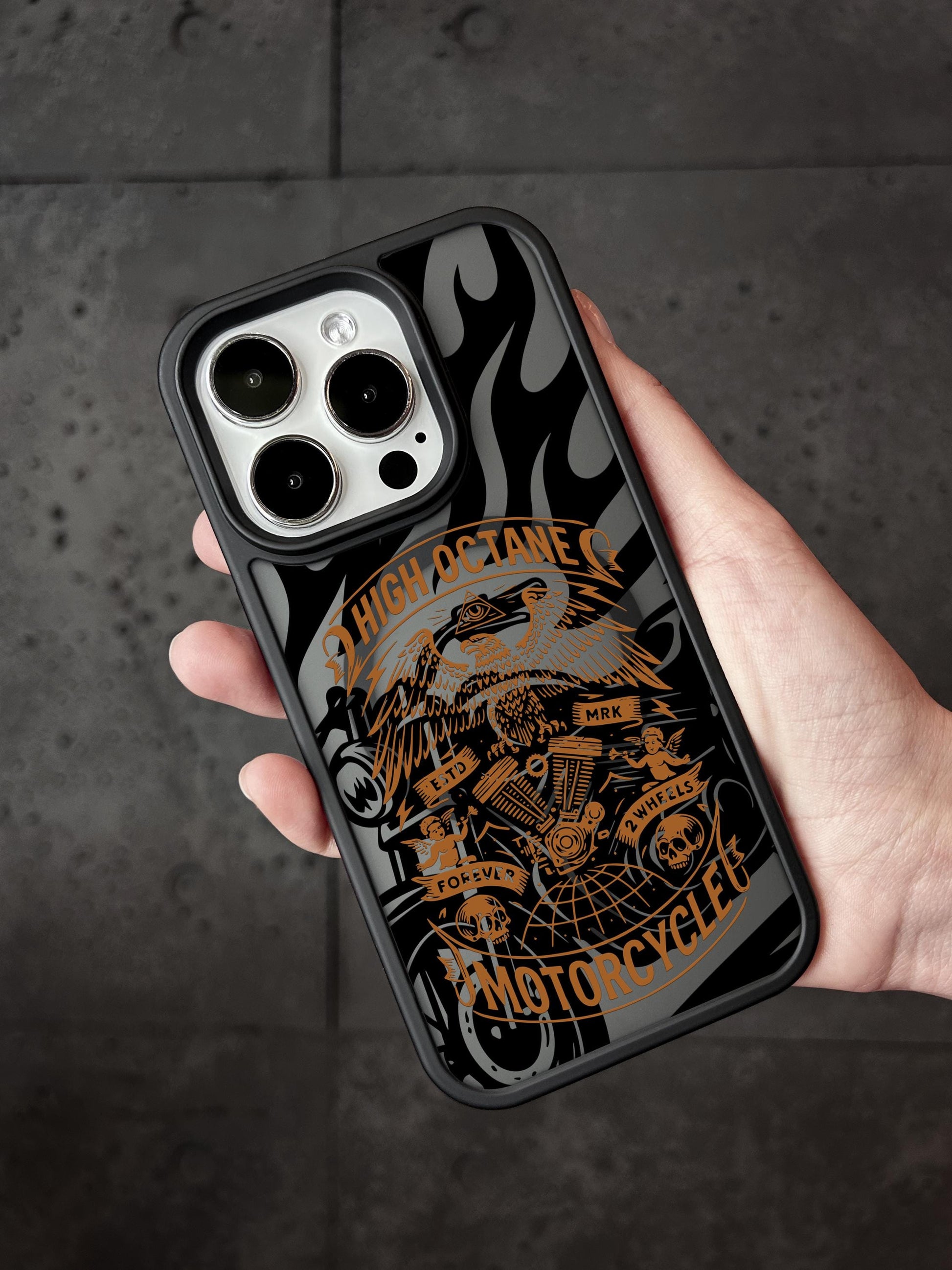 a person holding a phone case with a picture of a motorcycle