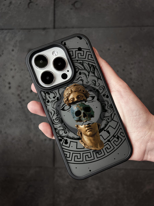 A person&#39;s hand holding a phone case with a design featuring a skull and a golden statue.