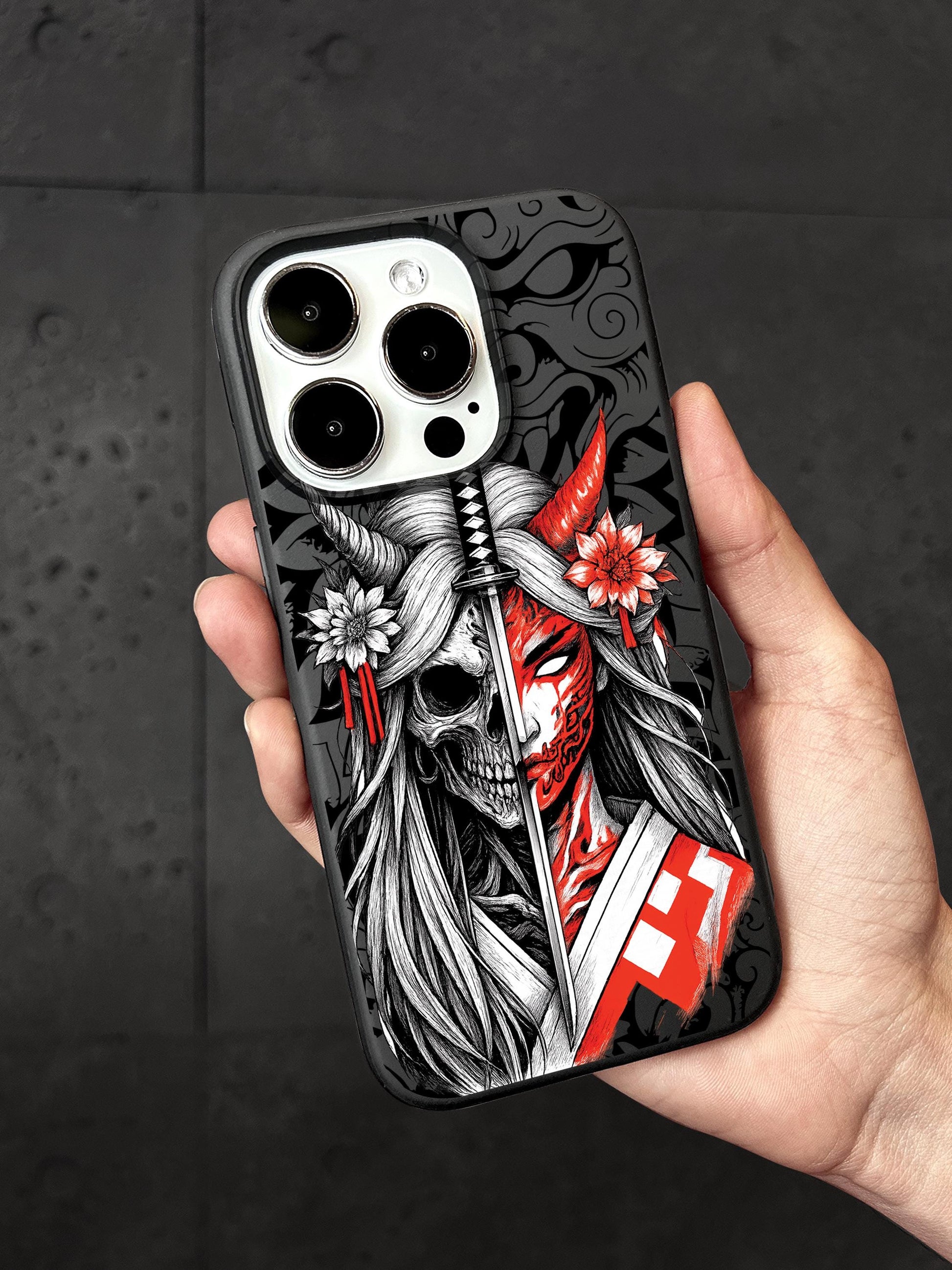 a person holding a phone case with a skull on it
