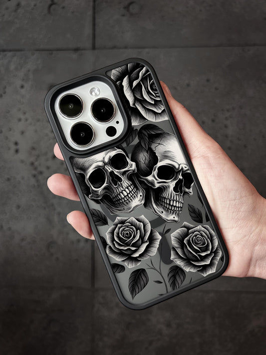 a person holding a phone case with skulls and roses on it