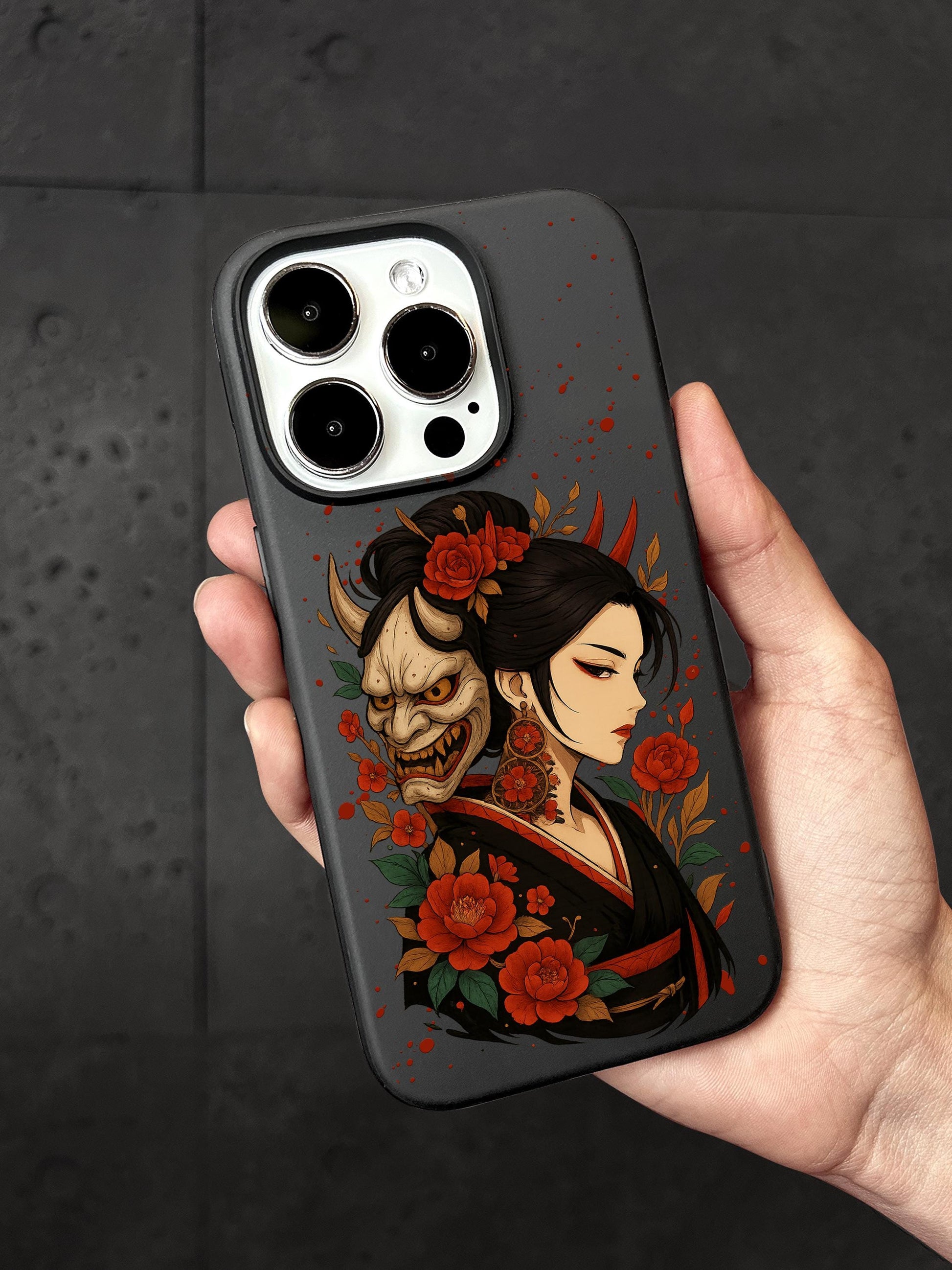 a person holding a phone case with a skull on it