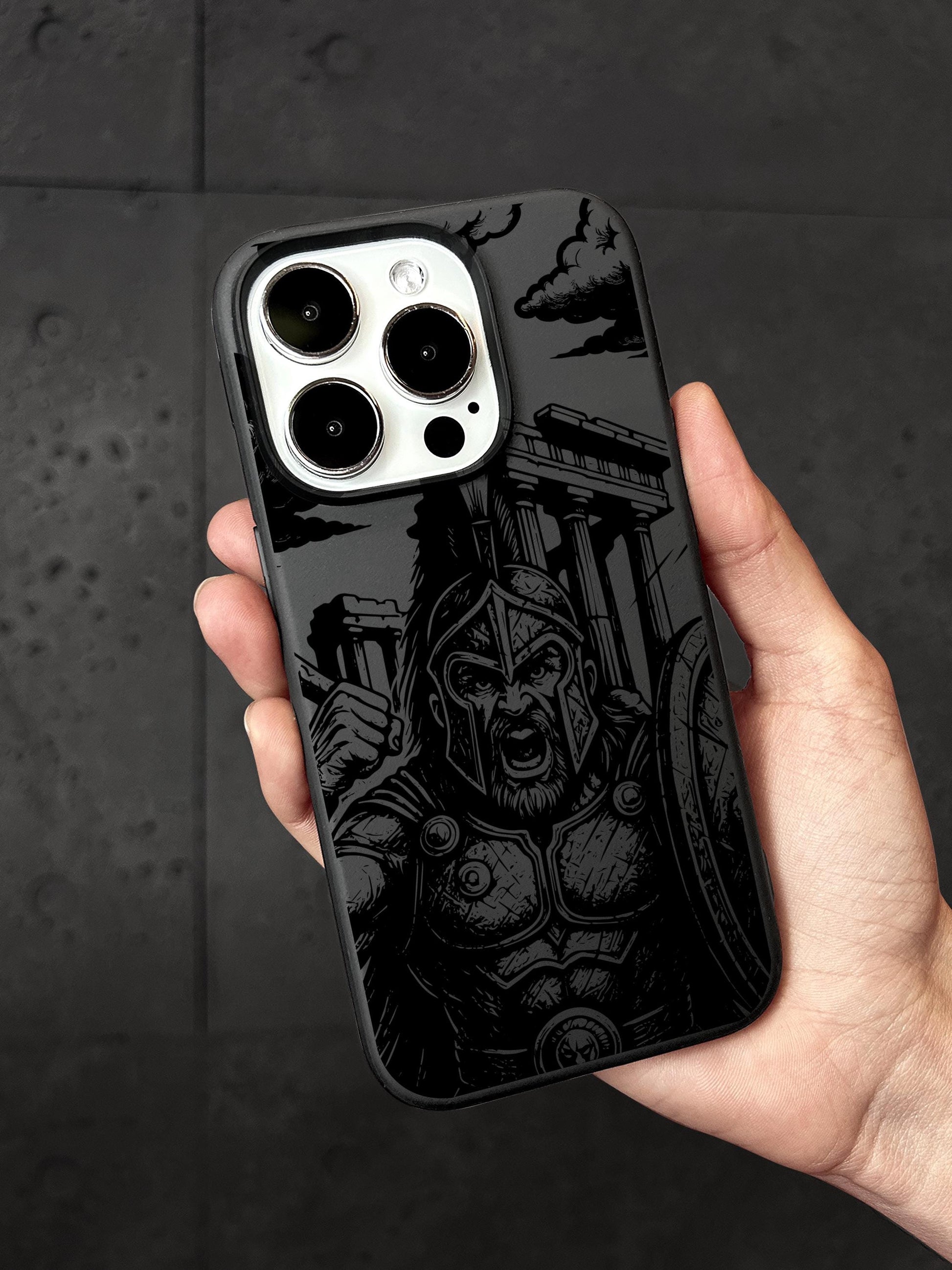 a hand holding a black and white iphone case