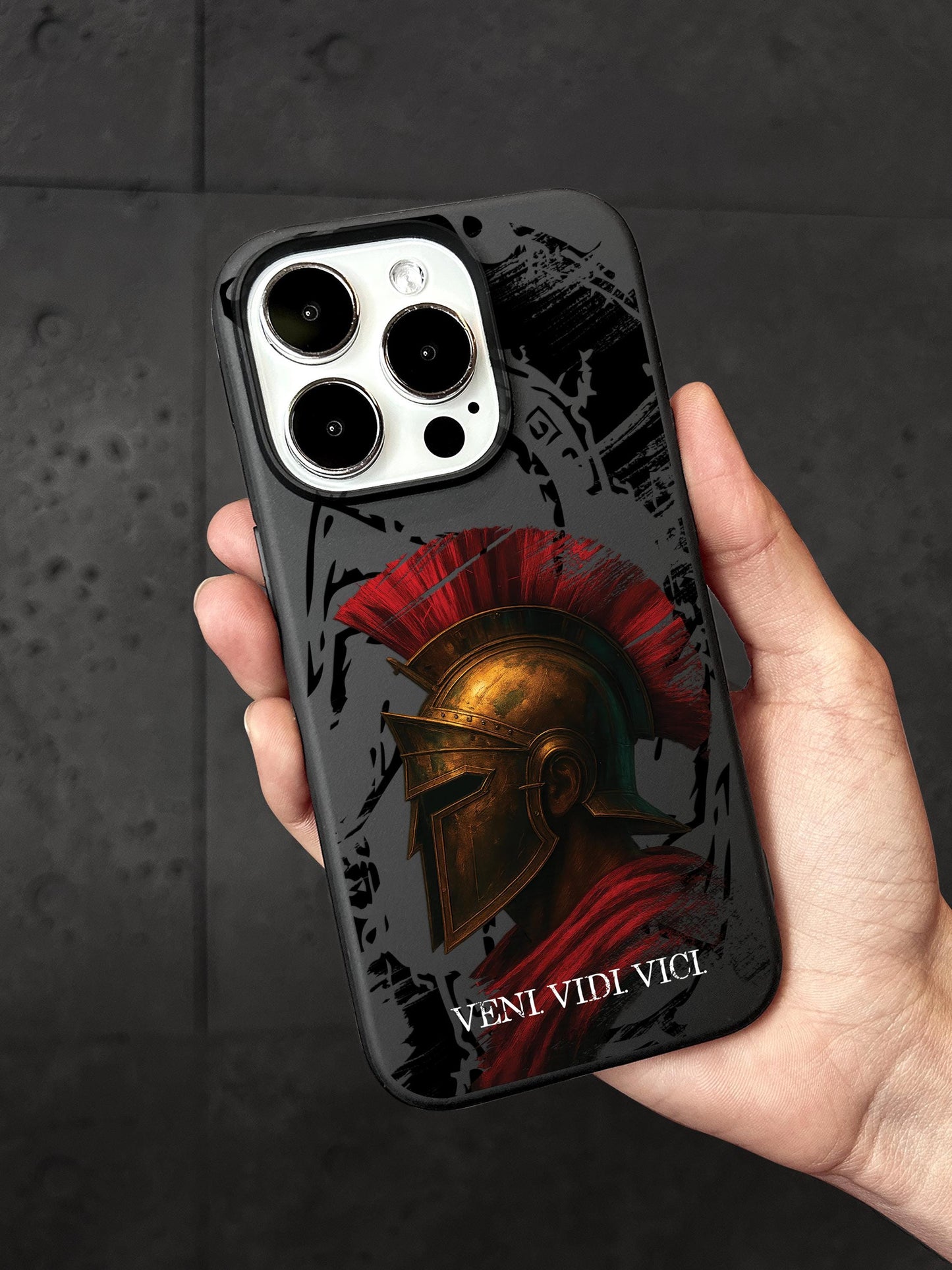a hand holding a phone case with a spartan helmet on it