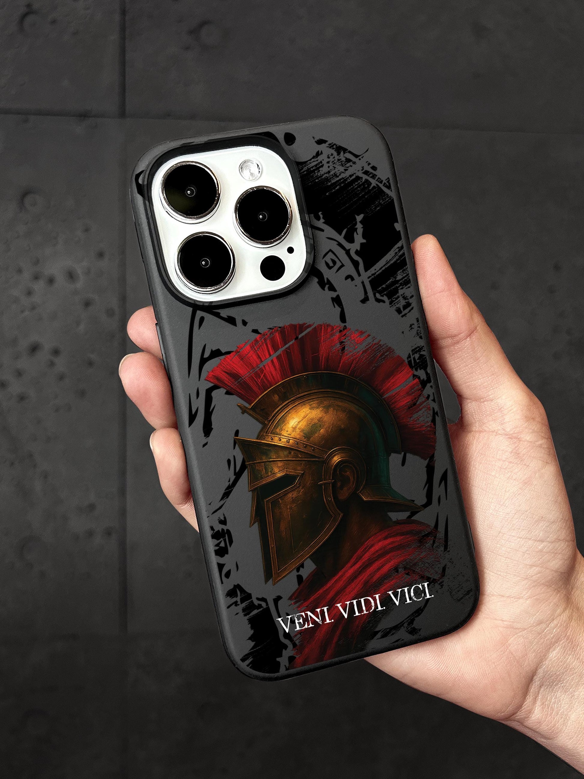 a hand holding a phone case with a spartan helmet on it
