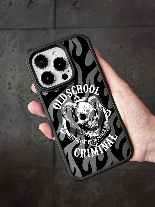 a person holding an iphone case with a skull on it