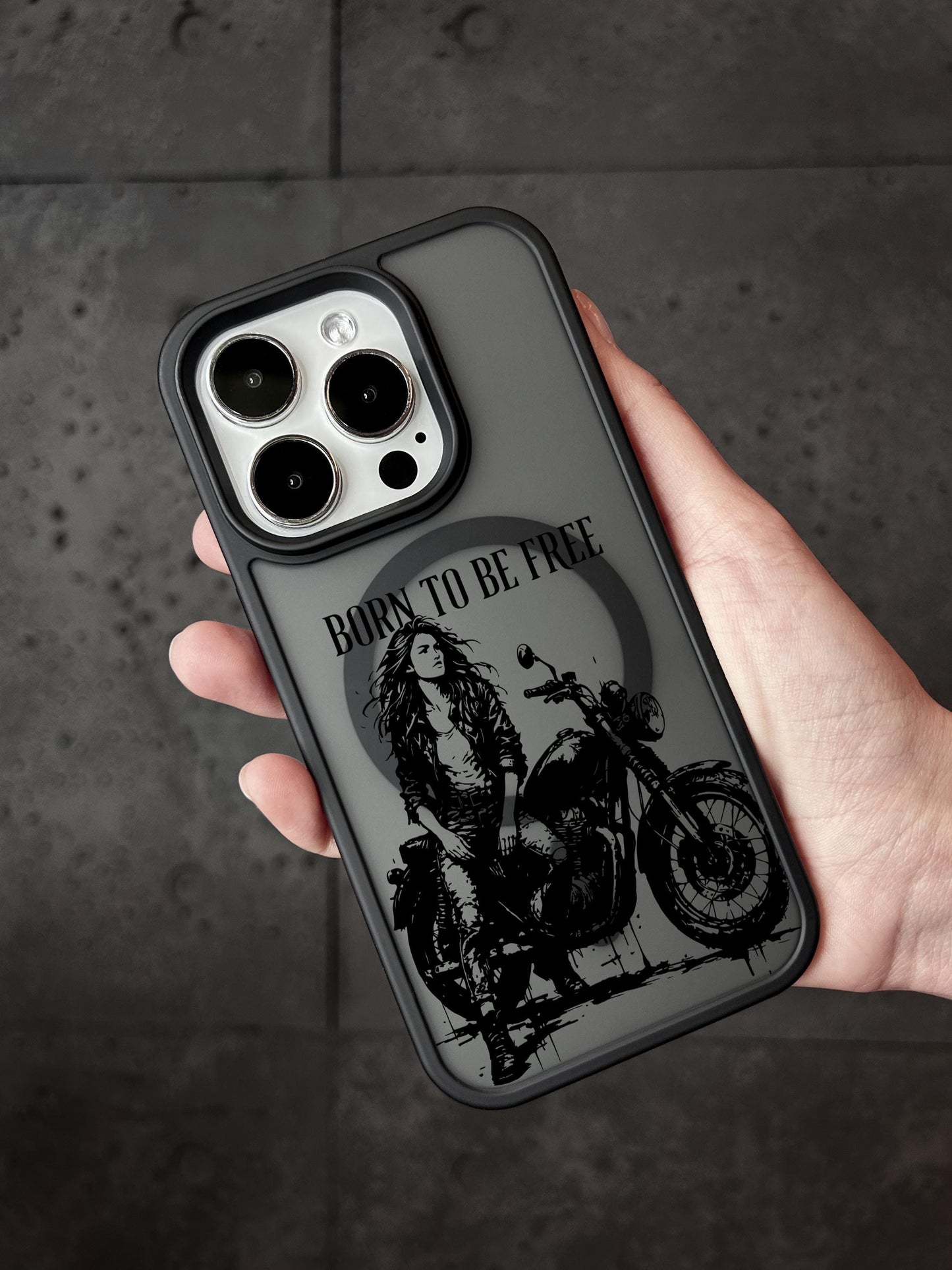 a person holding a phone case with a picture of a woman on a motorcycle