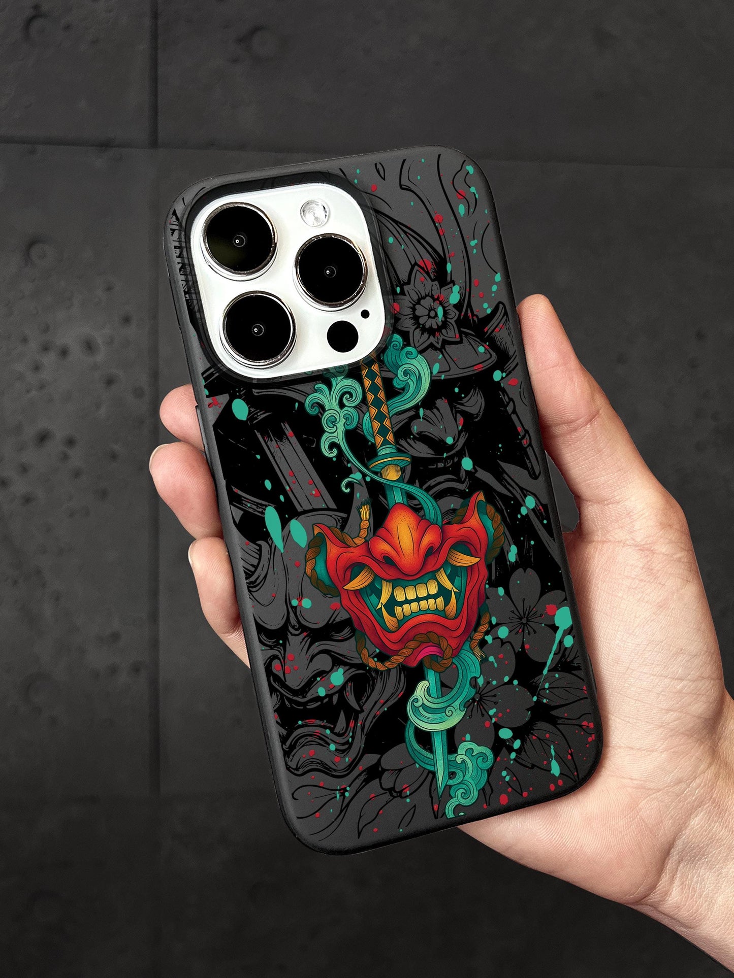 a hand holding a phone case with a skull on it