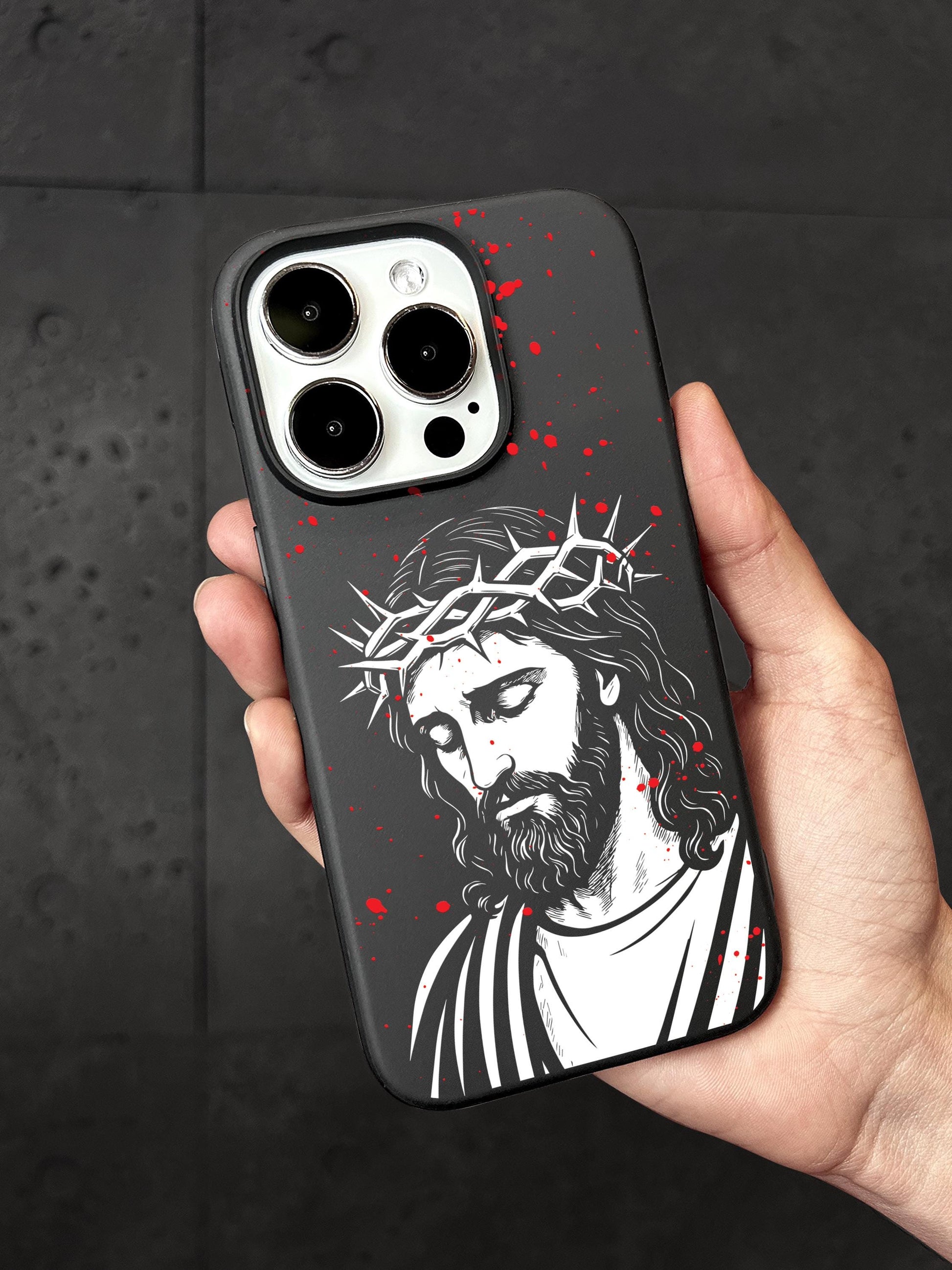 a hand holding a phone case with a picture of jesus