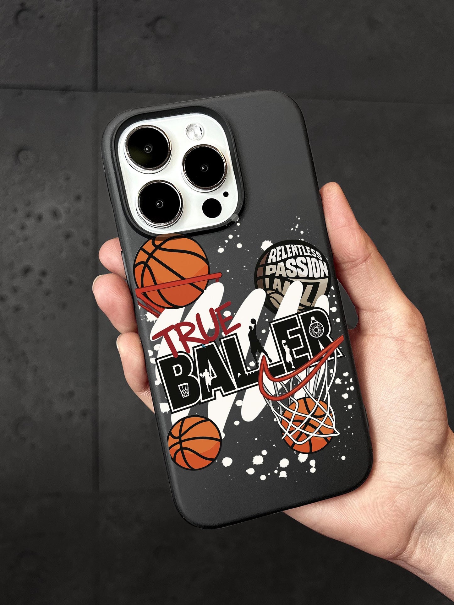 A person&#39;s hand holding a black phone case with basketball-related graphics and text printed on it.