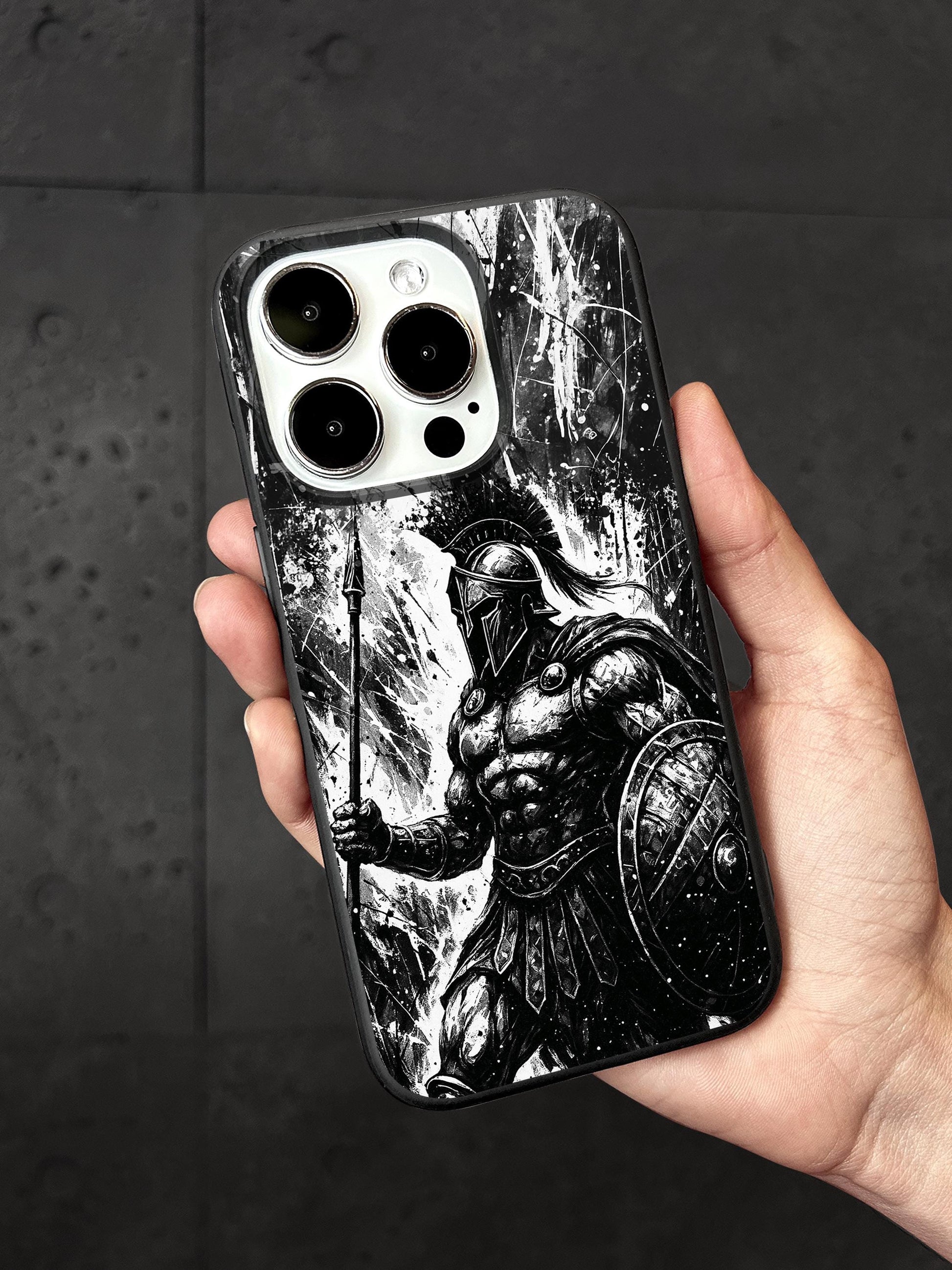 a hand holding a black and white iphone case