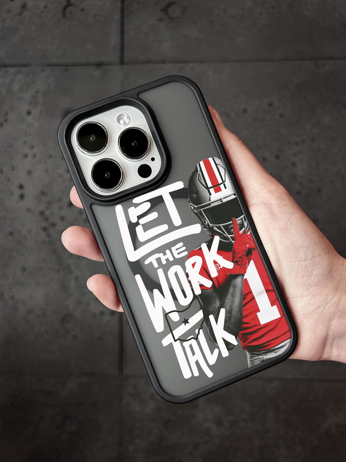 A person holding a phone case with a football player and the text &quot;LET THE WORK TALK&quot; printed on it.
