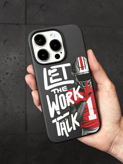 A person&#39;s hand holding a phone case with a football player&#39;s image and the text &quot;LET THE WORK TALK&quot; printed on it.