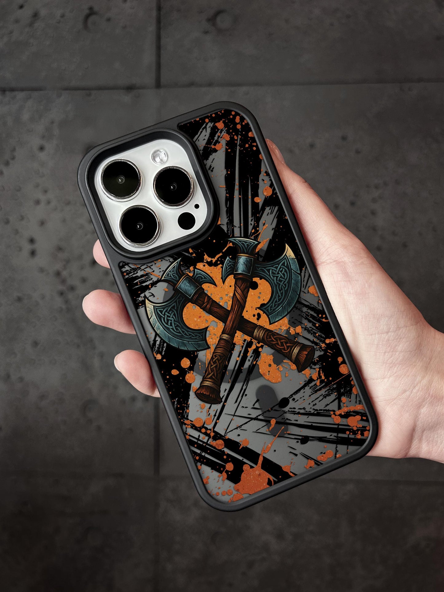 a person holding a phone case with a cross on it