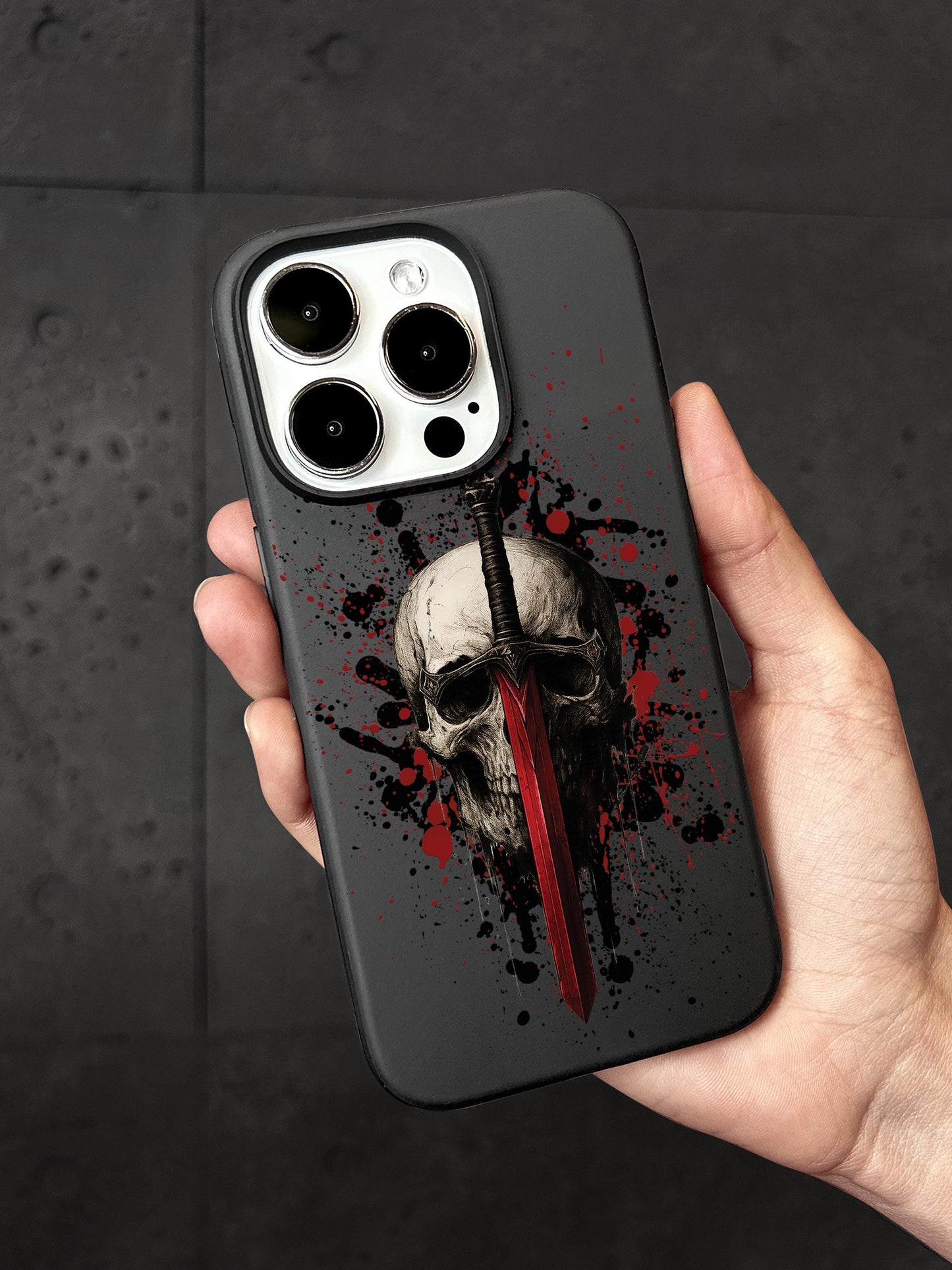 a person holding a phone case with a skull on it