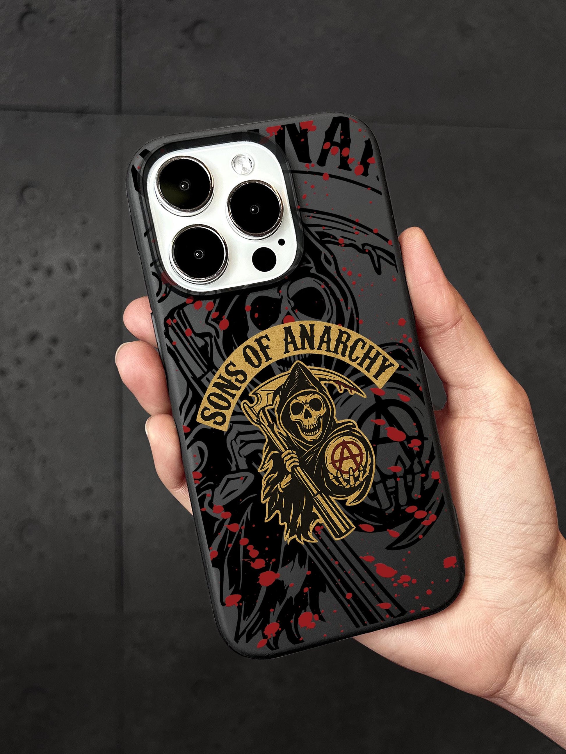 a person holding a phone case with a skull on it