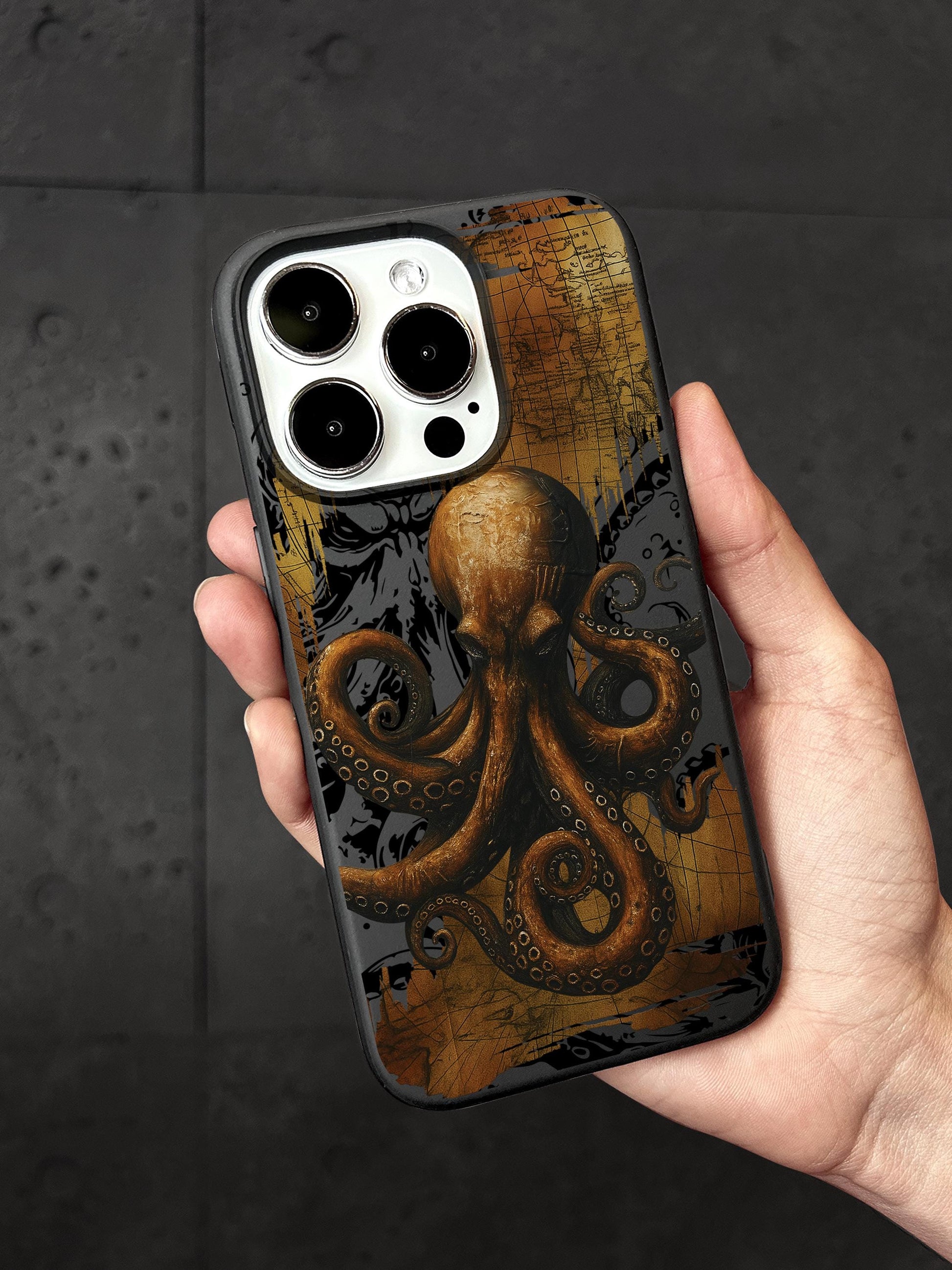 a hand holding a phone case with an octopus on it