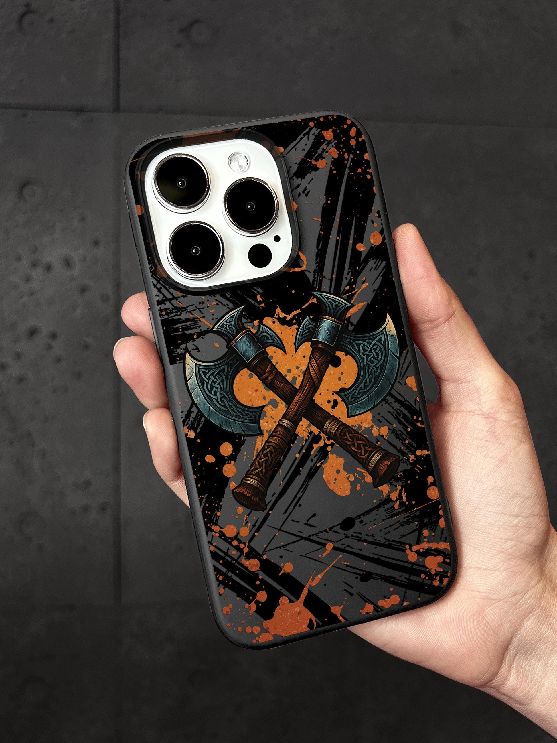 a hand holding a phone case with a picture of a cross on it