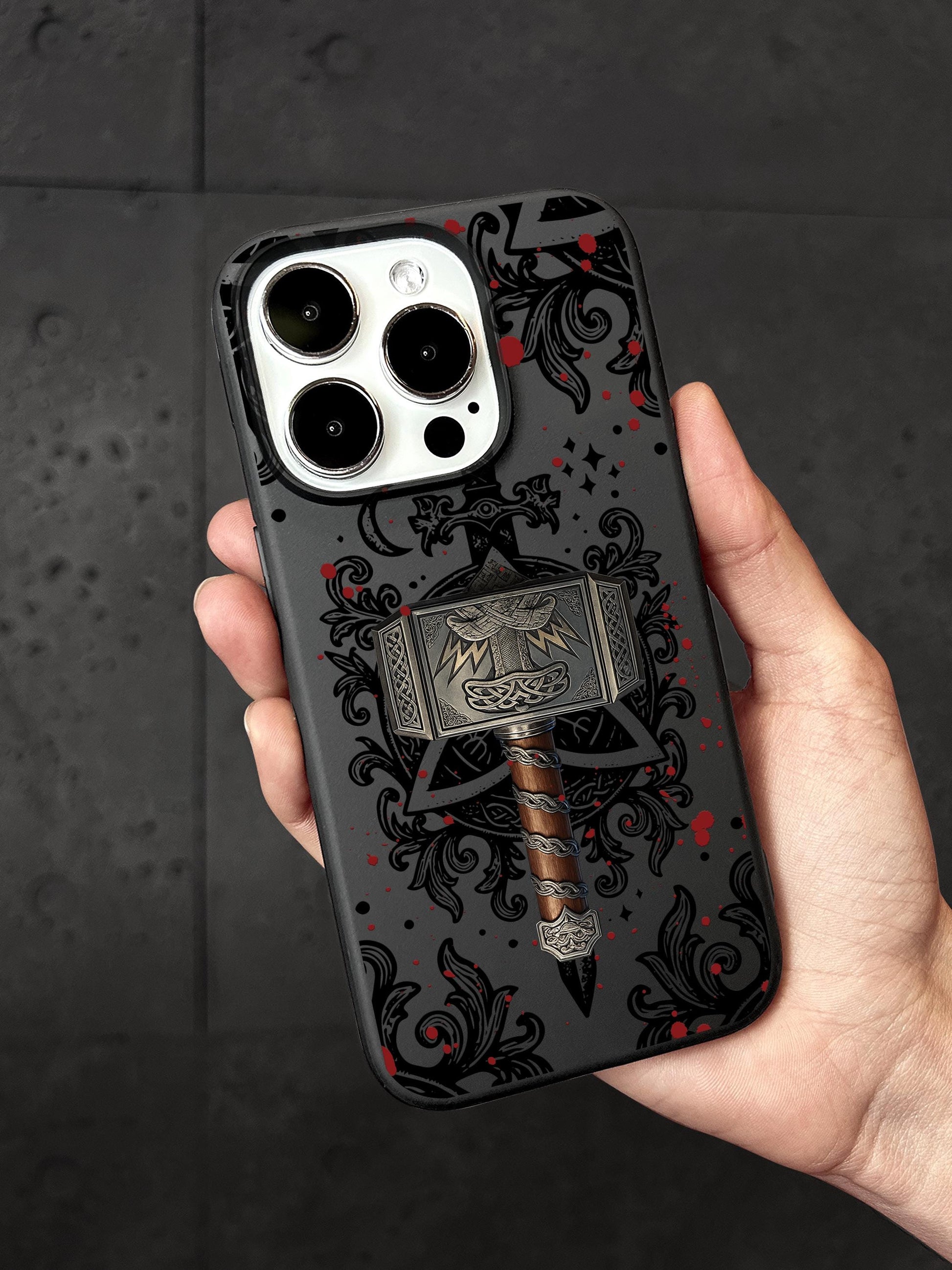a person holding a phone case with a hammer on it