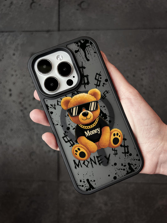 A person&#39;s hand holding a phone case featuring a teddy bear wearing sunglasses and a black shirt with the word &quot;Money&quot; printed on it.