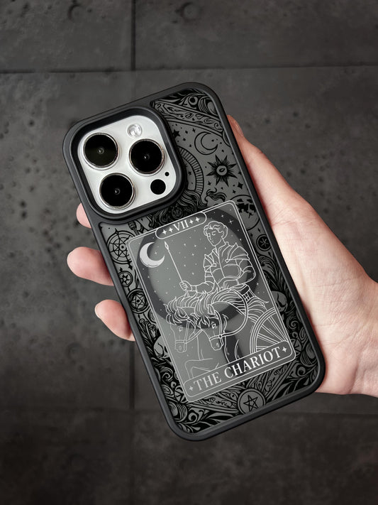 A hand holding a phone case with a detailed design featuring a tarot card image.