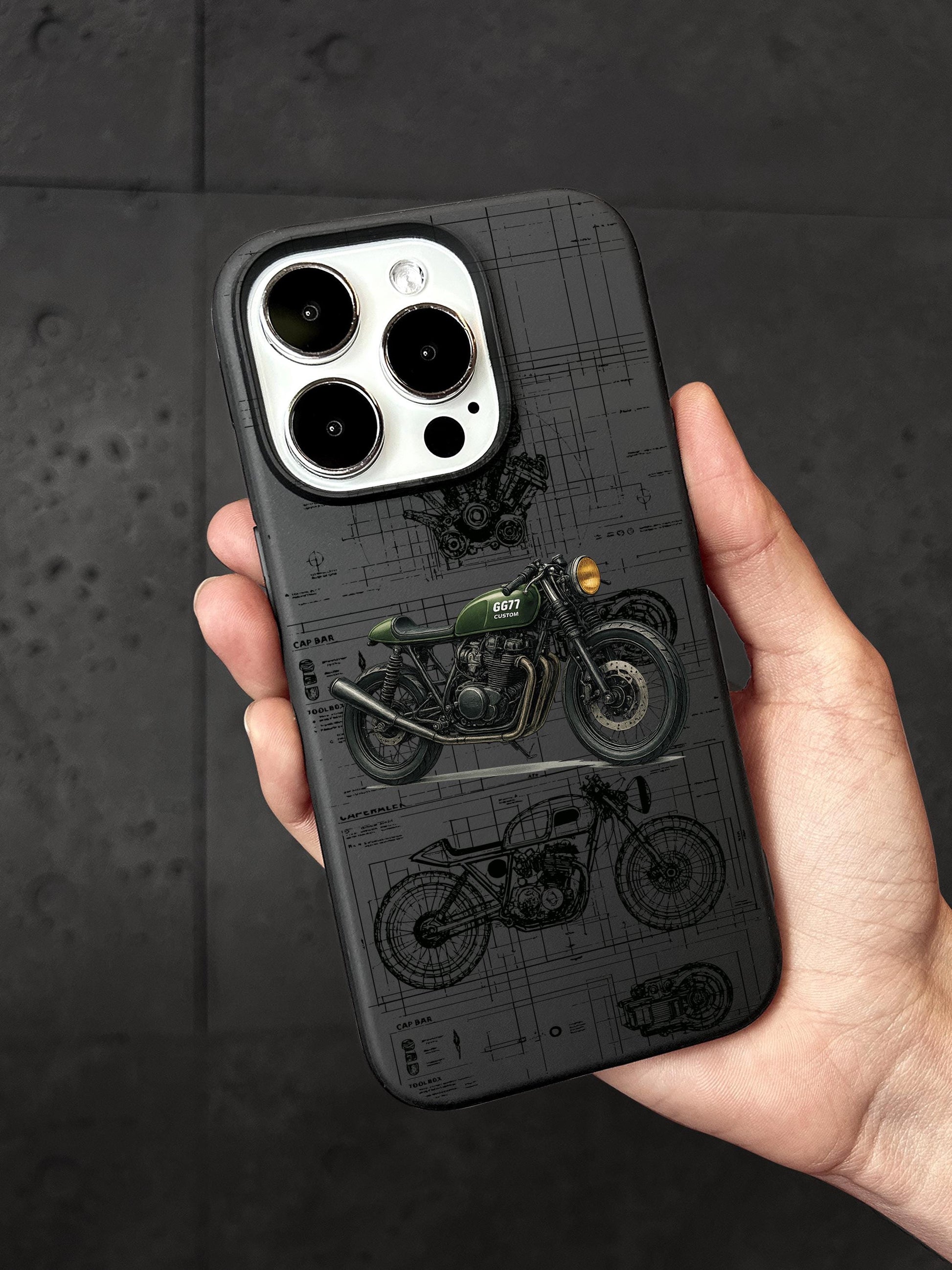 A person&#39;s hand holding a phone case with a motorcycle design printed on it.