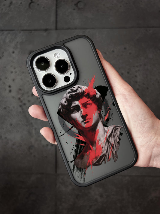 A hand holding a phone case with a stylized image of a person&#39;s face on it.