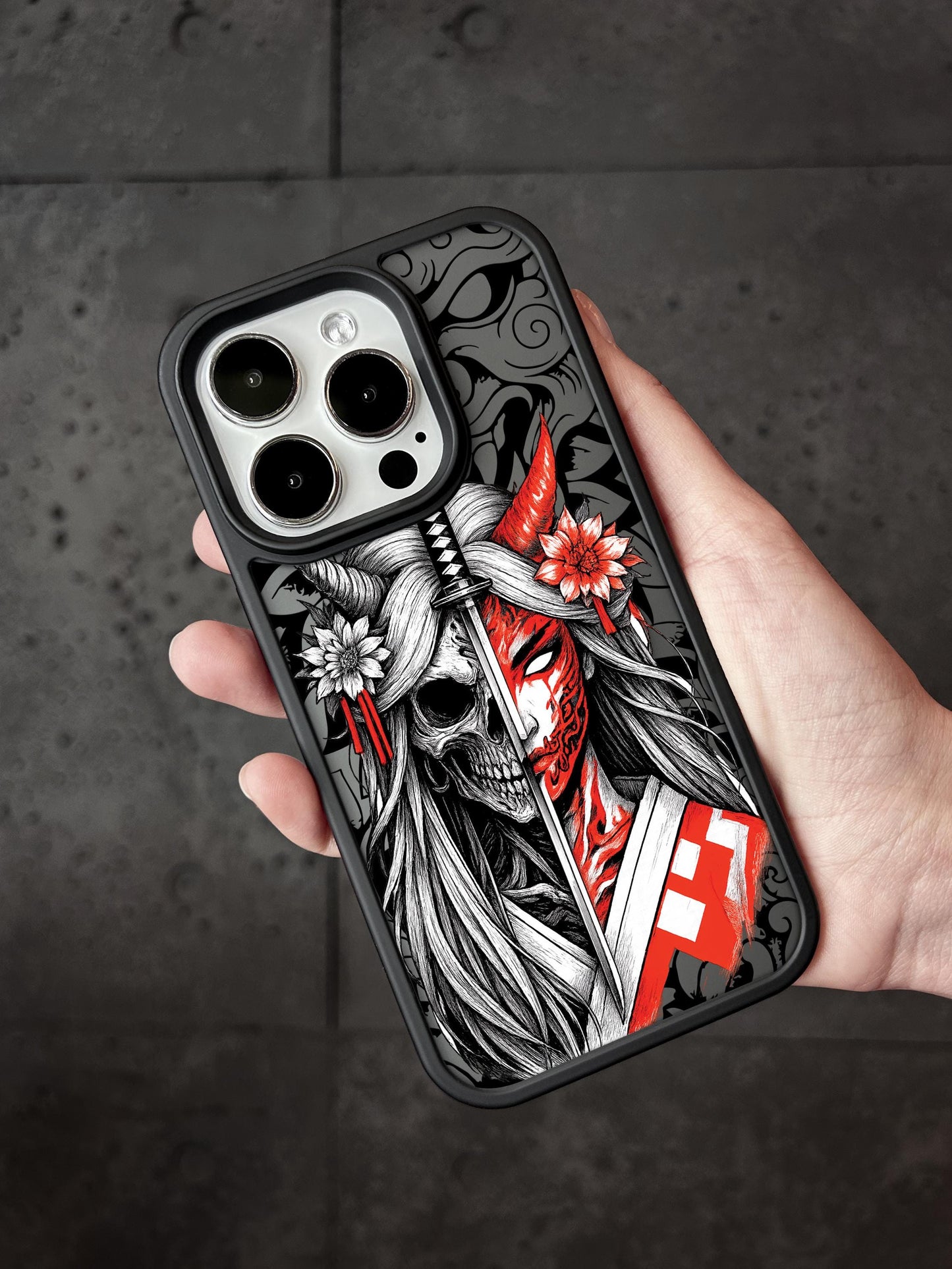 a person holding a phone case with a skull on it