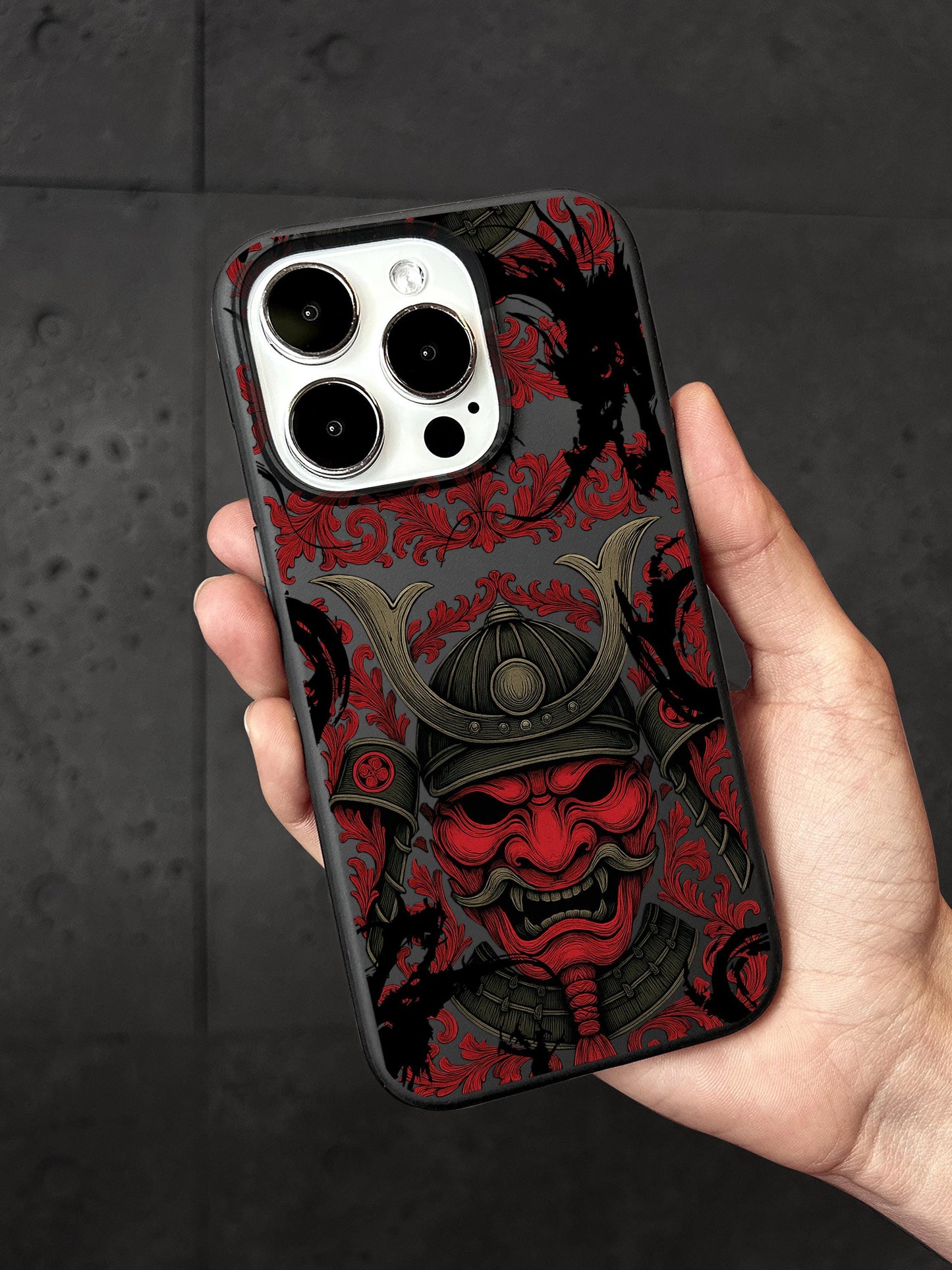 a hand holding a red and black phone case