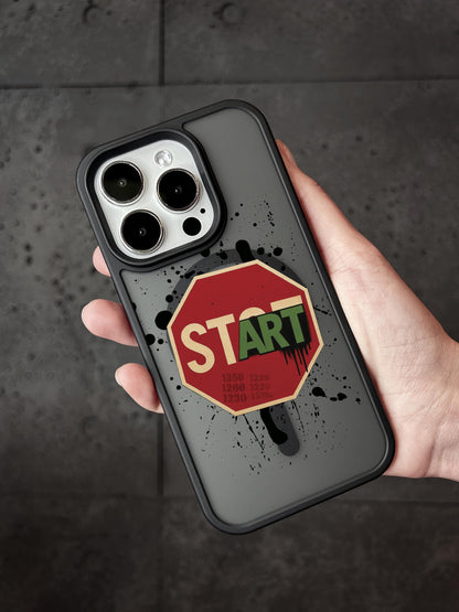 A hand holding a phone case with a stop sign sticker and the word &quot;START&quot; printed on it.